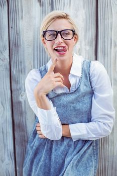 Pretty blonde woman having fun on wooden background