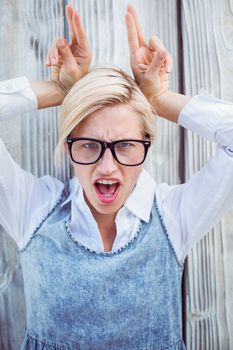 Pretty blonde woman having fun on wooden background