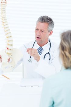 Doctor having conversation with his patient in medical office