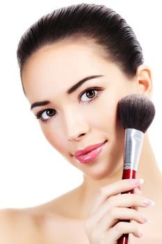 Beautiful girl with a makeup brush, white background, isolated