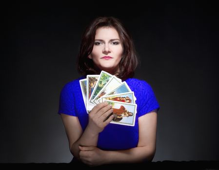 Woman in Blue Dress Holding Tarot Cards