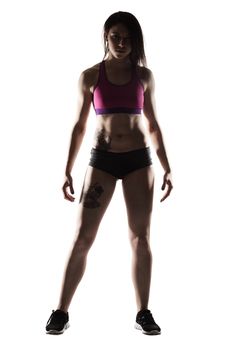 Fitness girl. Sexy body of athletic woman in shadows