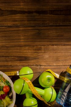 Indicators of healthy lifestyle on wooden table