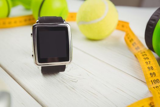 Watch with indicators of healthy lifestyle on wooden table