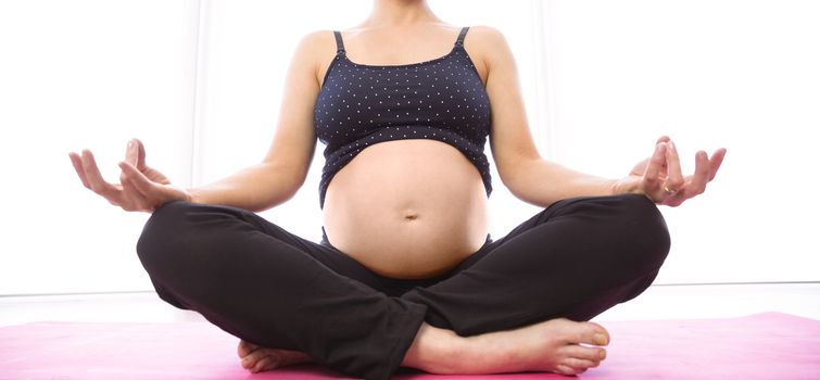 Pregnant woman keeping in shape at home