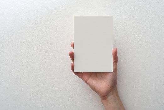 hand holding blank card on white background