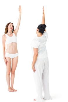 Relaxed women doing yoga on white background