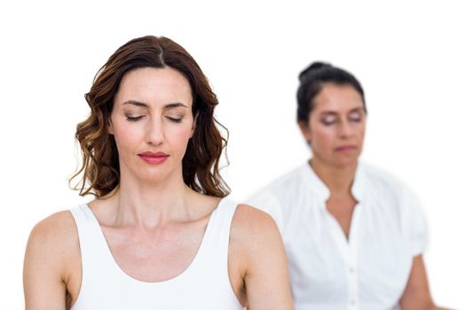 Women sitting in lotus pose on white background