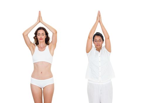 Relaxed women raising arms on white background