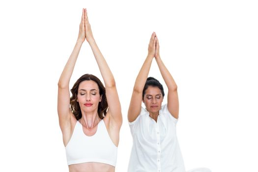 Relaxed women raising arms on white background