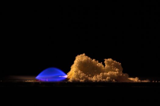 A macro photography of burning sulfur powder.