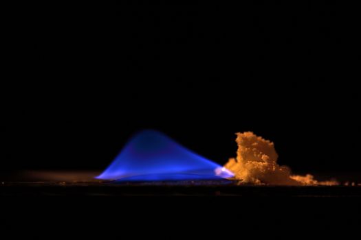 A macro photography of burning sulfur powder.