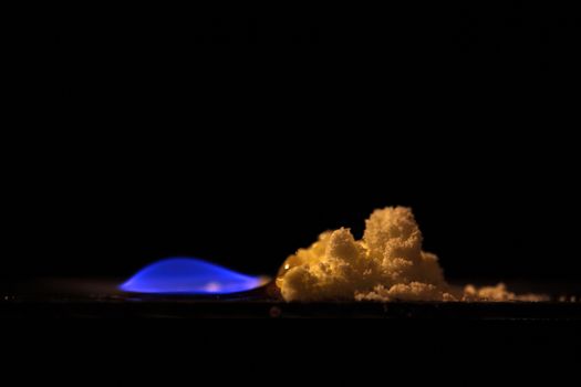 A macro photography of burning sulfur powder.