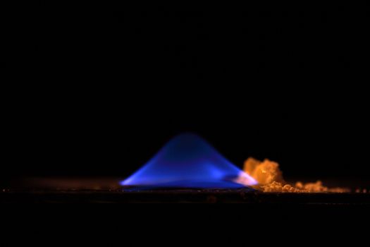 A macro photography of burning sulfur powder.