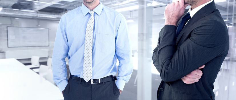 Frowning businessman thinking  against classroom