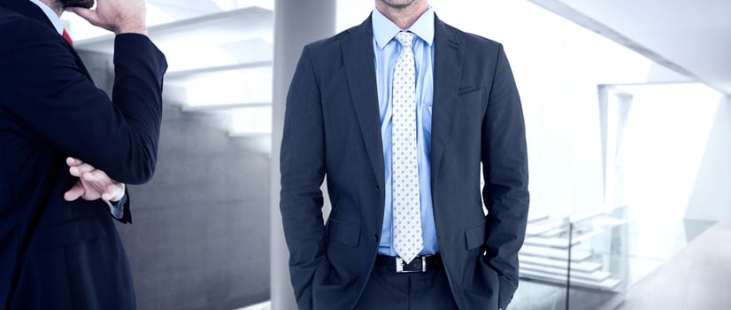 Businessman looking at the camera against stylish modern home interior with staircase