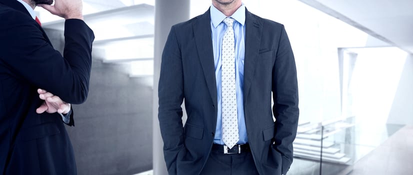 Businessman looking at the camera against stylish modern home interior with staircase