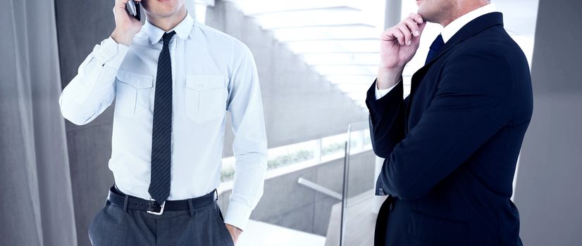 Elegant businessman in suit posing  against stylish modern home interior with staircase