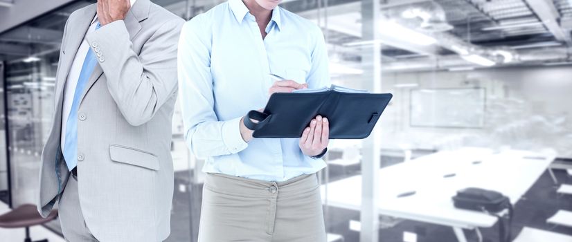 Businesswoman writing in her diary  against classroom