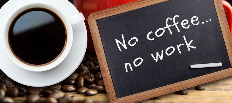 White cup of coffee against chalkboard with piece of chalk