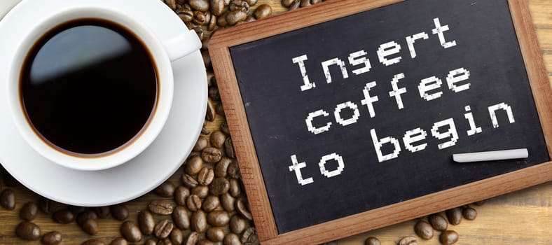 White cup of coffee against chalkboard with piece of chalk