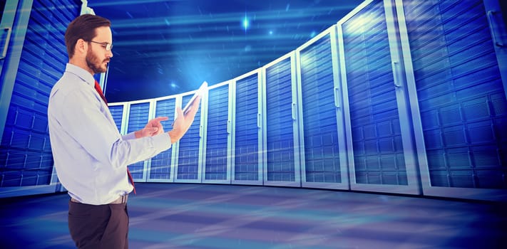 Businessman scrolling on his digital tablet against composite image of server towers