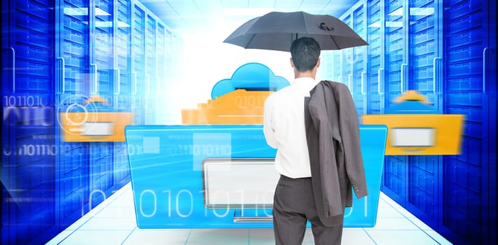 Businessman standing back to camera holding umbrella and jacket on shoulder against composite image of cloud computing drawer