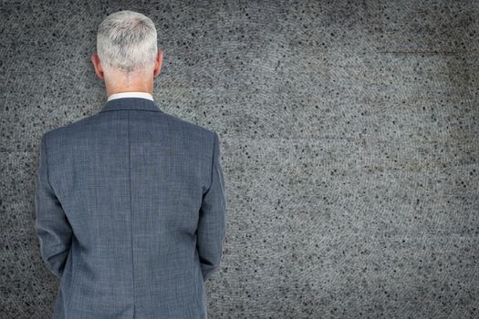 Businessman standing against grey background