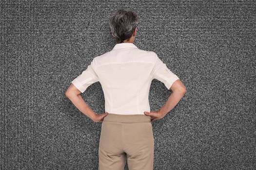 Businesswoman standing against black background