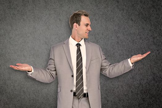 Businessman with hands out against grey background