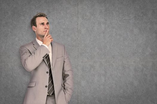 Thinking businessman against grey background