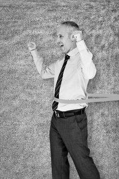 Businessman winning race against grey background