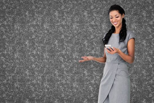 Businesswoman using smartphone  against grey background