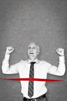 Businessman winning race against grey background