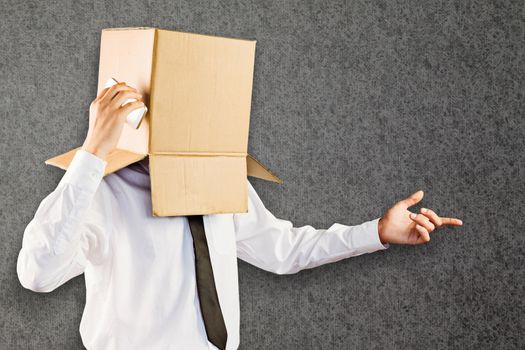 Anonymous businessman with his smartphone against grey background