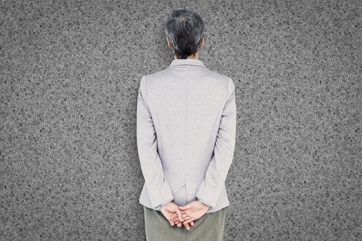 Businesswoman standing against grey background