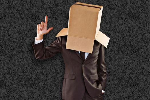 Anonymous businessman pointing up with finger against grey background