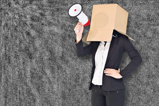 Anonymous businesswoman holding a megaphone against grey background