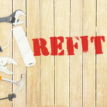 The word refit against tools on wooden background