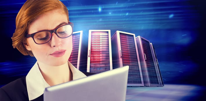 Redhead businesswoman using her tablet pc against composite image of server towers