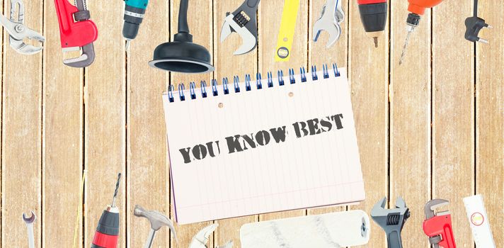 The word you know best against tools and notepad on wooden background