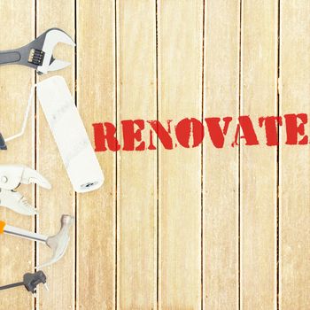 The word renovate  against tools on wooden background