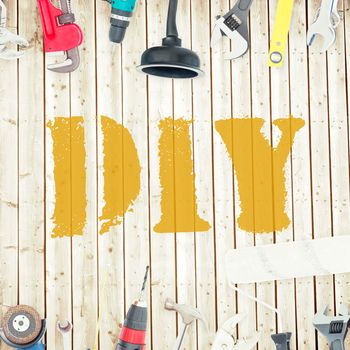 The word diy against tools on wooden background