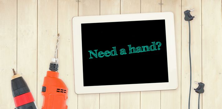 The word need a hand? against tools and tablet on wooden background