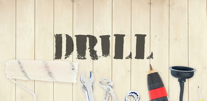 The word drill against diy tools on wooden background