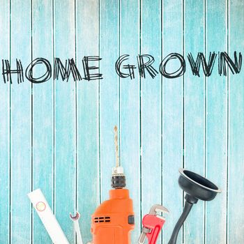 The word home grown against tools on wooden background