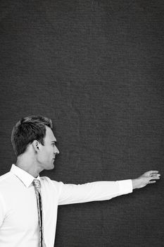 Businessman reaching against grey background