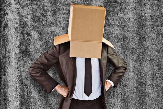 Anonymous businessman with hands on hips against grey background