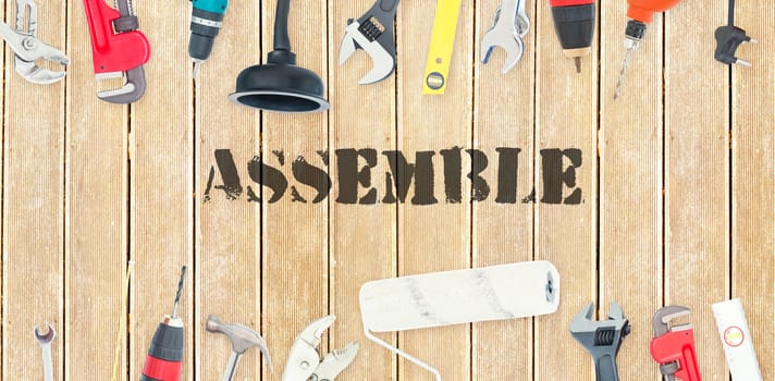 The word assemble against diy tools on wooden background