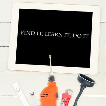 The word find it, learn it, do it against tools and tablet on wooden background